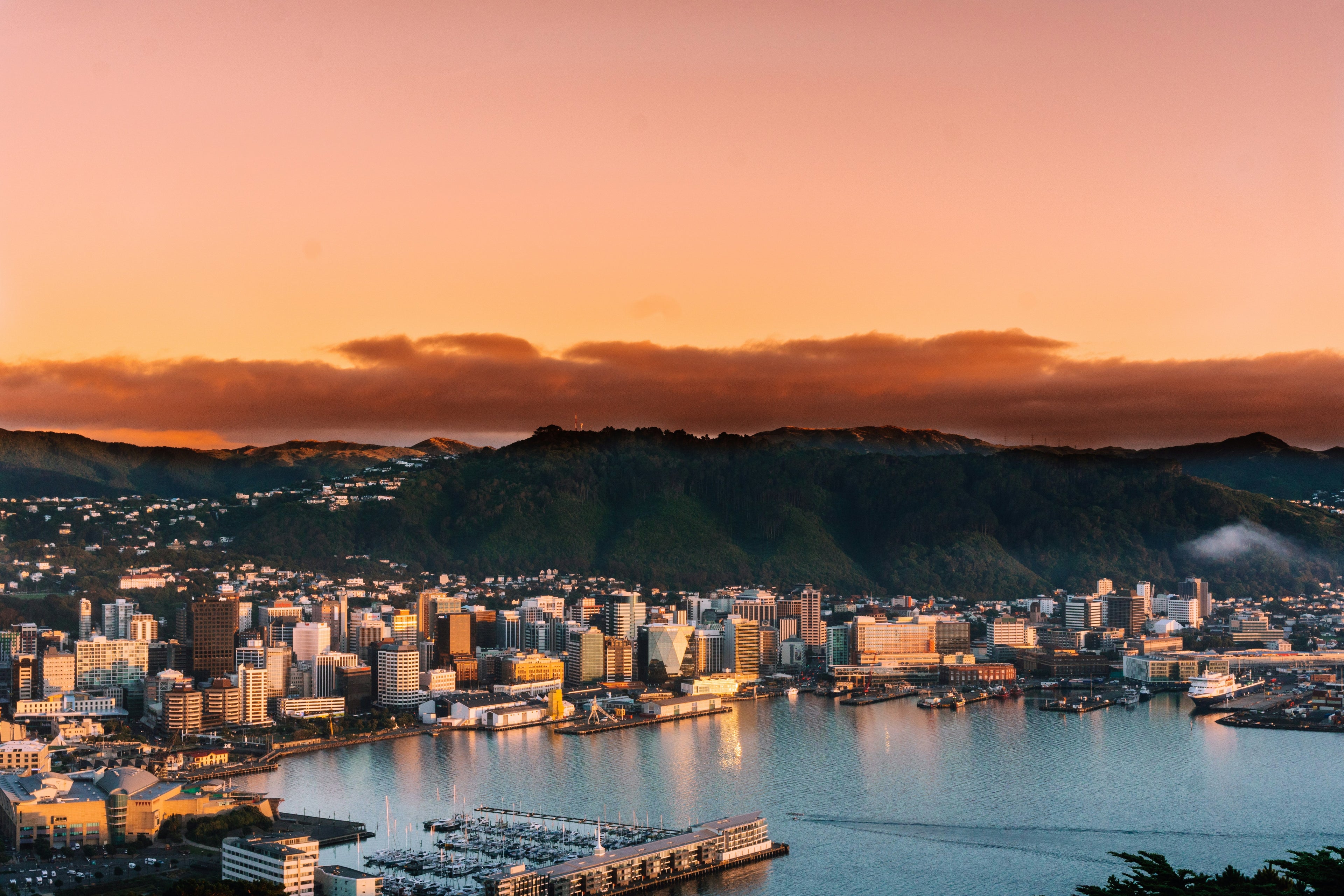 Cityscape with buildings and mountains at sunset